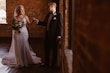 Bride Wearing Classic Elegant Wedding Dress Called Sebastiane By Maggie Sottero Holds Hand With Groom Near Window