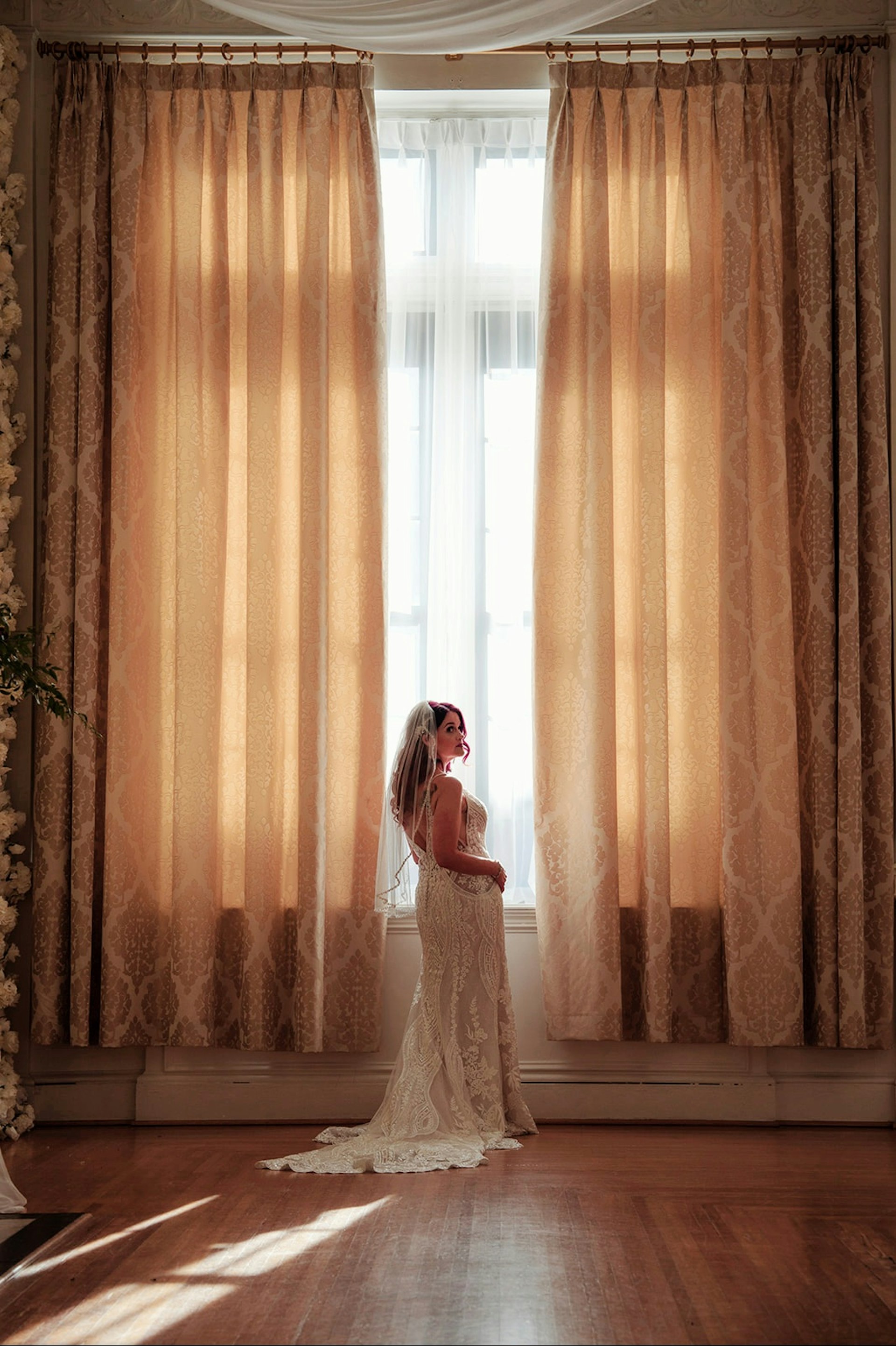 Bride wearing Bailey by Sottero and Midgley in front of curtains