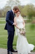 Groom holding bride close.