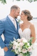 Bride Wearing Boho Sheath Wedding Dress Called Marisol By Rebecca Ingram With Groom Holding White And Pink Bouquet