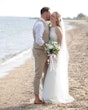 Bride wearing Davis Leigh wedding dress by Sottero and Midgley being kissed by her husband