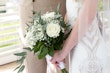 Bride wearing Davis Leigh wedding dress by Sottero and Midgley holding her bouquet