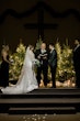 Bride And Groom Standing Together At The Altar. Bride Wearing Glamorous Mikado Mermaid Wedding Dress Called Pippa By Rebecca Ingram