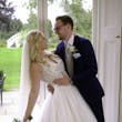 Bride In Lace A-Line Wedding Dress Called Taylor By Maggie Sottero With Long Veil And Groom