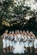 Bride and bridesmaids all in ivory with dried and wild flower bouquets.