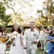 Bride wearing Lettie by Rebecca Ingram walking out of their ceremony