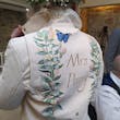 Bride In Long Sleeve Lace Wedding Dress Called Iris By Rebecca Ingram In Personalized Leather Jacket
