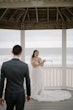 Bride wearing Frederique wedding gown by Maggie Sottero looking at groom