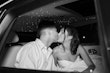 Bride wearing Anniston by Maggie Sottero kissing her husband in the car