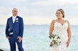 Groom Gazing at Bride in Lovely Plus Size Fit-and-Flare Tulle Wedding Dress with Delicate Lace Motifs Accented with Beading Called Glorietta Lynette by Maggie Sottero