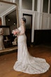 Bride Wearing Rustic Lace Wedding Dress Called Larkin Lynette By Rebecca Ingram Next To A Large Mirror