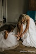 Bride Wearing Aline Satin Wedding Gown Called Scarlet By Maggie Sottero With Flower Girl Helping Her Get Ready