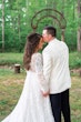 Bride Wearing Dreamy Long Bishop Lace Sleeve Wedding Dress Called Finley By Sottero And Midgley And Groom Kissing Forehead Near Green Forest