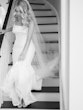 Bride Wearing Simple Fit And Flare Wedding Dress Called Mitchell Marie By Maggie Sottero Walking Down The Stairs