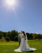 Bride Wearing Lace Long Sleeve Aline Wedding Dress Called Winter By Maggie Sottero In A Field With Groom