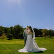 Bride Wearing Lace Long Sleeve Aline Wedding Dress Called Winter By Maggie Sottero In A Field With Groom