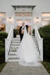 Bride Wearing Lace Princess Dress Called Harlem By Maggie Sottero With Groom On Stairs