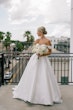 Bride wearing Zinaida by Maggie Sottero looking out over a balcony