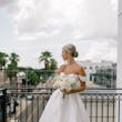 Bride wearing Zinaida by Maggie Sottero looking out over a balcony