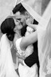 Bride Wearing Lace Backless Wedding Dress Called Chauncey By Sottero And Midgley Kissing Groom