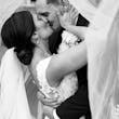 Bride Wearing Lace Backless Wedding Dress Called Chauncey By Sottero And Midgley Kissing Groom