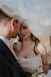 Bride wearing Aspen by Sottero and Midgley under her veil with her husband