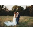 Bride Wearing Sparkly Aline Wedding Dress Called Anniston Lane By Maggie Sottero Holding Groom In A Field