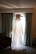 Savannah Wedding Dress by Maggie Sottero Hanging in Window.