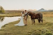 Bride Wearing Keyhole Back Halter Wedding Dress Called Bellarose By Rebecca Ingram With Groom And A Horse