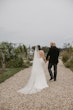 Bride wearing Luella wedding dress by Sottero and Midgley holding hands with her husband