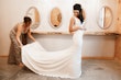 Bride with mother wearing satin sheath wedding dress.
