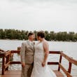 Bride wearing Tuscany Marie wedding dress by Maggie Sottero standing with her husband