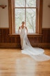 Bride wearing simple sheath wedding dress with V-neck.