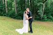 Groom with bride wearing simple crepe wedding dress Bertina by Maggie Sottero.