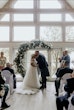 Bride wearing Rousseau wedding dress by Maggie Sottero kissing her husband