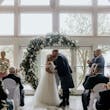 Bride wearing Rousseau wedding dress by Maggie Sottero kissing her husband