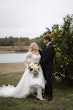 Bride In Off The Shoulder Lace Wedding Dress Called Tiffany By Maggie Sottero With Groom And Cowboy Boots