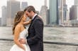 Bride Wearing Simple Ballgown Wedding Dress Called Fortune By Maggie Sottero With Groom With A City Skyline Behind Them