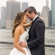 Bride Wearing Simple Ballgown Wedding Dress Called Fortune By Maggie Sottero With Groom With A City Skyline Behind Them