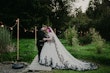 Bride Wearing Gothic Black Lace Wedding Dress Called Tristyn By Maggie Sottero With Groom In A Garden