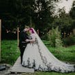 Bride Wearing Gothic Black Lace Wedding Dress Called Tristyn By Maggie Sottero With Groom In A Garden