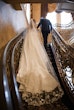 Bride wearing Barcelona by Sottero and Midgley walking up the stairs with her husband