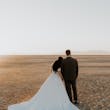 Bride And Groom Together. Bride Wearing Simple Ball Gown Wedding Dress With An Elegant Overskirt Called Kyrie By Maggie Sottero