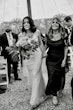 Bride wearing Luella wedding dress by Sottero and Midgley walking down the aisle with her mother