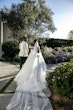 Bride wearing Tatiana wedding dress by Maggie Sottero walking with her husband