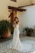 Bride wearing Cecilia by Rebecca Ingram putting in earrings