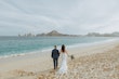 Groom Walking On Beach With Bride In A White Beaded Wedding Dress Named Jonah Lane By Sottero And Midgley