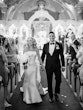 Bride Wearing Simple Fit And Flare Wedding Dress Called Mitchell Marie By Maggie Sottero Walking Down The Aisle With Groom