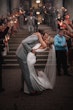 Bride with groom wearing simple sheath wedding dress with V-neck.