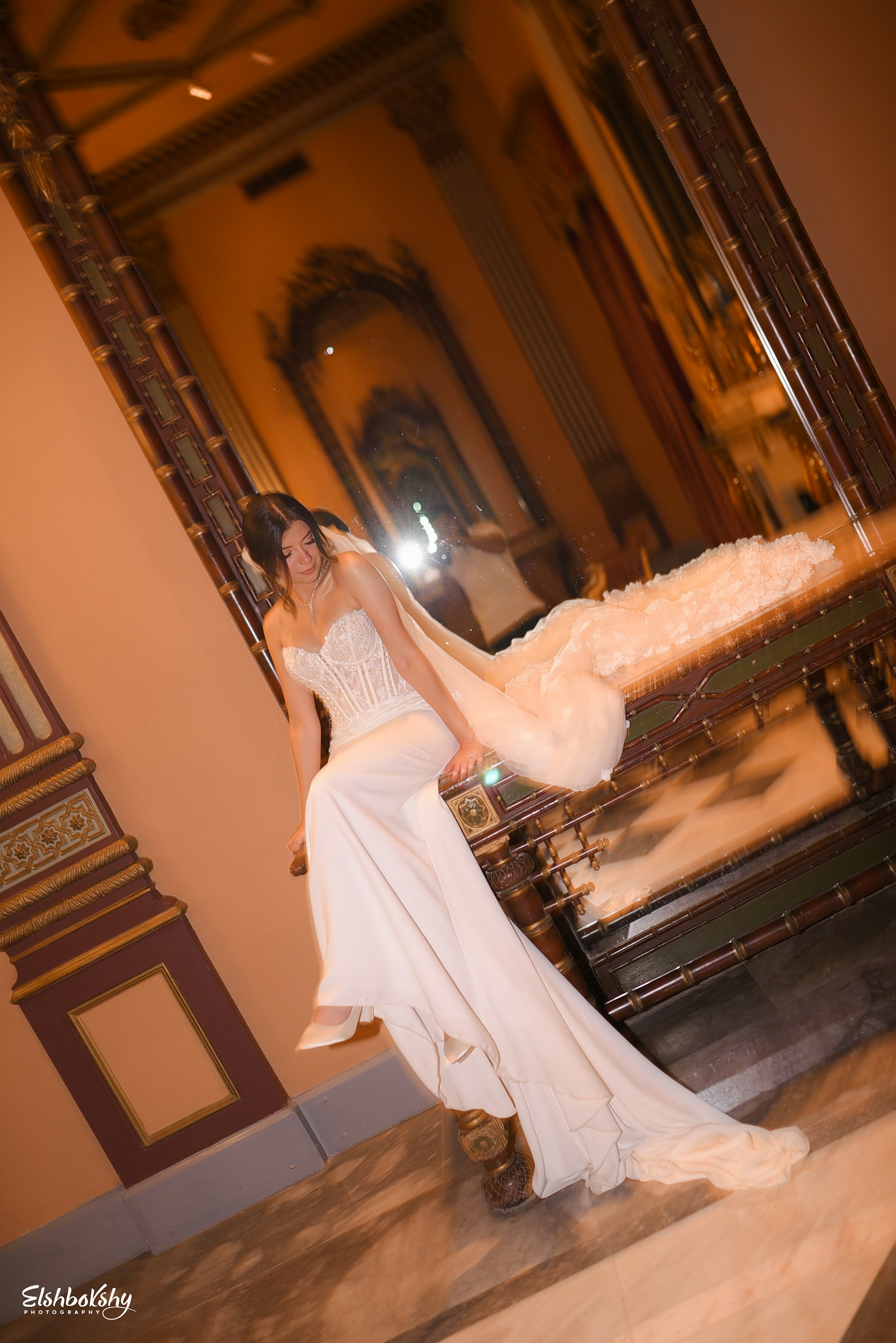 Bride Wearing Sheath and Beaded Wedding Dress Called Doritte By Maggie Sottero Next To A Mirror